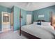 Spacious bedroom with a four-poster bed, blue walls, and doorway to an attached bathroom at 1335 Hopton Cir # 1335, Mount Pleasant, SC 29466