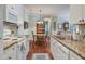 Open kitchen view with granite counters, white cabinets, stainless appliances, and dining area at 1335 Hopton Cir # 1335, Mount Pleasant, SC 29466