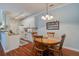 Open kitchen and dining area with white cabinets, granite countertops, and hardwood floors at 1335 Hopton Cir # 1335, Mount Pleasant, SC 29466