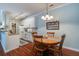 Open kitchen and dining area with white cabinets, granite countertops, and hardwood floors at 1335 Hopton Cir # 1335, Mount Pleasant, SC 29466