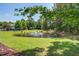Scenic view of a pond with a fountain, surrounded by lush greenery and trees at 1335 Hopton Cir # 1335, Mount Pleasant, SC 29466