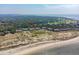 Expansive aerial view showcasing beachfront townhomes and proximity to amenities at 1376 Pelican Watch Villas, Seabrook Island, SC 29455
