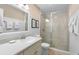 Bright bathroom with white wainscoting, glass shower door, and a neutral vanity at 1376 Pelican Watch Villas, Seabrook Island, SC 29455