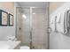 Neutral bathroom showcasing a glass shower, white vanity, and framed coastal artwork at 1376 Pelican Watch Villas, Seabrook Island, SC 29455