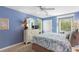 Comfortable bedroom with blue walls, a dresser with mirror, a window nook, and a cozy rug, creating a peaceful retreat at 1376 Pelican Watch Villas, Seabrook Island, SC 29455