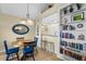 Charming dining area featuring a round table with blue chairs, nautical decor, and built-in shelving at 1376 Pelican Watch Villas, Seabrook Island, SC 29455