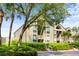 Attractive condo exterior featuring lush landscaping, mature trees, and reserved parking at 1376 Pelican Watch Villas, Seabrook Island, SC 29455