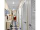 Inviting hallway with checkered flooring, showcasing a mix of modern and nautical decor, creating a unique atmosphere at 1376 Pelican Watch Villas, Seabrook Island, SC 29455