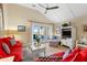 Cozy living room with vaulted ceilings, comfortable red couches, and a scenic view from the sliding glass doors at 1376 Pelican Watch Villas, Seabrook Island, SC 29455