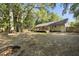 Secluded backyard features a firepit, a wood deck, privacy fence and a large mature tree canopy at 1445 Downwood Pl, Charleston, SC 29412