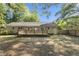 The backyard of the home has a wooden deck, a privacy fence, and is surrounded by lush trees and foliage at 1445 Downwood Pl, Charleston, SC 29412