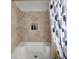 Well-maintained bathtub with tile surround and niche for bath products and decor at 1445 Downwood Pl, Charleston, SC 29412