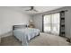 Cozy bedroom with ample natural light from the large window and neutral carpet at 1445 Downwood Pl, Charleston, SC 29412