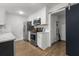 Stylish kitchen featuring white shaker cabinets, stainless appliances, and a modern sliding barn door at 1445 Downwood Pl, Charleston, SC 29412
