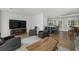Open concept living room featuring hardwood floors, modern recliners, and stylish media center at 1445 Downwood Pl, Charleston, SC 29412