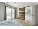 Bright main bedroom with a wooden sliding door to the ensuite bathroom with updated vanity at 1445 Downwood Pl, Charleston, SC 29412