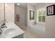 Bathroom featuring double sinks, tiled floors, and separate tub and shower at 152 Candace Dr, Ridgeville, SC 29472