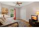 Bright bedroom features daybed, wood floors, ceiling fan and colorful decorative touches at 152 Candace Dr, Ridgeville, SC 29472
