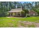 Beautiful brick home with an expansive green lawn, mature trees, and detached garage at 152 Candace Dr, Ridgeville, SC 29472