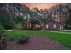 Beautiful property showcasing a brick home with lush landscaping and a detached garage at 152 Candace Dr, Ridgeville, SC 29472