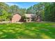 Well-maintained brick home with a green lawn and mature trees at 152 Candace Dr, Ridgeville, SC 29472