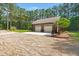 Detached two car garage features a bench and an extended parking pad at 152 Candace Dr, Ridgeville, SC 29472