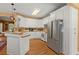 Bright kitchen featuring white cabinetry, stainless steel appliances, and hardwood floors at 152 Candace Dr, Ridgeville, SC 29472