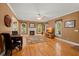 Cozy living room featuring a fireplace, hardwood floors, and natural light from large windows at 152 Candace Dr, Ridgeville, SC 29472
