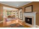 Living room with hardwood floors, fireplace, and seamless transition into the bright dining area at 152 Candace Dr, Ridgeville, SC 29472