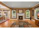 Comfortable living room featuring a fireplace, large windows, and hardwood floors throughout at 152 Candace Dr, Ridgeville, SC 29472