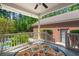 Covered back patio with outdoor rug, stairs, white railings, and a view of surrounding trees at 152 Candace Dr, Ridgeville, SC 29472