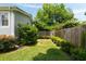 Green backyard with lawn and border landscaping and privacy fence provides space for recreation and relaxation at 158 Darlington Ave, Charleston, SC 29403