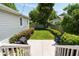 Inviting backyard featuring a concrete patio, manicured lawn, privacy landscaping, and the home's pale siding at 158 Darlington Ave, Charleston, SC 29403