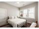 This bedroom has ample natural light, wood floors, and neutral wall paint at 158 Darlington Ave, Charleston, SC 29403