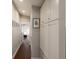 Hallway leading to bedroom featuring white storage and hardwood floors at 158 Darlington Ave, Charleston, SC 29403