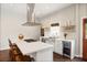 Bright and airy kitchen featuring a wine fridge, open shelving, and a spacious island at 158 Darlington Ave, Charleston, SC 29403
