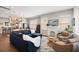 Open-concept living area with a modern fireplace, hardwood floors, and a comfortable sectional sofa at 158 Darlington Ave, Charleston, SC 29403