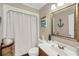 Cozy bathroom with a single sink vanity, framed mirror, and a shower with a neutral-colored curtain at 166 River Breeze Dr, Charleston, SC 29407