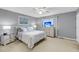 Well-lit bedroom features carpet, dresser with a TV, and a window view at 166 River Breeze Dr, Charleston, SC 29407