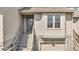 Inviting front entrance with a gray door, white siding, and well-maintained landscaping at 166 River Breeze Dr, Charleston, SC 29407