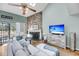 Bright living area with stone fireplace, TV and nearby access to outdoor deck at 166 River Breeze Dr, Charleston, SC 29407