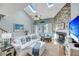 Bright living room boasts a vaulted ceiling, fireplace, skylights and comfortable seating for relaxation at 166 River Breeze Dr, Charleston, SC 29407