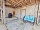 Cozy patio featuring comfortable wicker seating, decorative lattice, and a well-maintained outdoor grill at 166 River Breeze Dr, Charleston, SC 29407