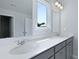 This bathroom has a large vanity with dual sinks, quartz countertops, and modern fixtures at 187 E Pinckney St, Summerville, SC 29485