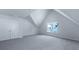 An attic bedroom with cozy carpeting, natural light, and a closet at 187 E Pinckney St, Summerville, SC 29485