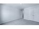 Bright bedroom featuring a closet, doorway, and neutral carpet at 187 E Pinckney St, Summerville, SC 29485