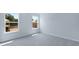 The light and airy bedroom has bright windows, neutral walls, and gray carpeting at 187 E Pinckney St, Summerville, SC 29485