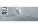 This bedroom has neutral walls, plush gray carpet, and two windows providing natural light at 187 E Pinckney St, Summerville, SC 29485