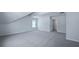 A cozy attic bedroom with comfortable carpeting, natural light, and a doorway at 187 E Pinckney St, Summerville, SC 29485