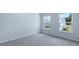 A well-lit bedroom with soft carpeting and bright double windows at 187 E Pinckney St, Summerville, SC 29485